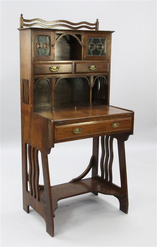 An Arts & Crafts oak students desk, H.4ft 8in. W.2ft 3in.